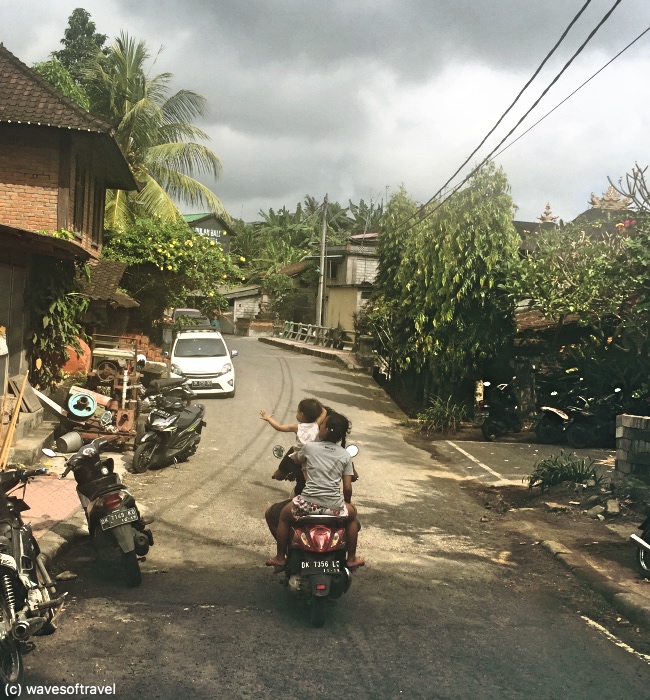 An Indonesian family making their way through the streets of Ubud.